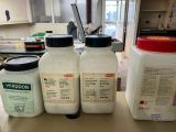 four bottles of milk sitting on a counter in a kitchen