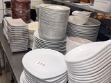 many plates stacked on the counter in the kitchen