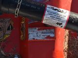a red fire hydrant with a black pipe attached to it