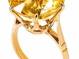 a close up of a ring with a large citrine stone