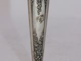 a silver vase that is sitting on a table