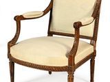 an image of a wooden chair with a beige upholstered seat