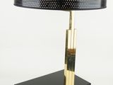 a black table lamp with a gold base and a black shade