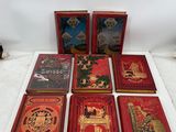 six red books sitting on top of a white table