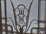 an old iron fireplace screen with a decorative design on the top of it