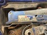 a blue box with tools in it and a wrench