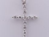 a diamond cross pendant on a white background