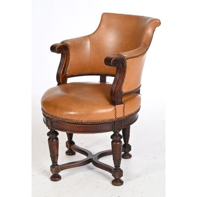an image of a brown leather chair with a wooden frame