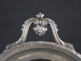 a silver plate with a clock on top of it
