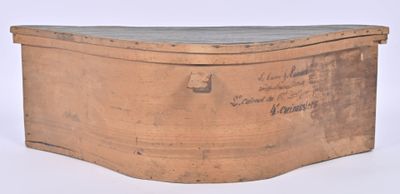 a wooden box with writing on it on a white surface