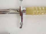 a close up of a knife on a white surface