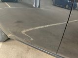 a car parked in a parking lot next to a building