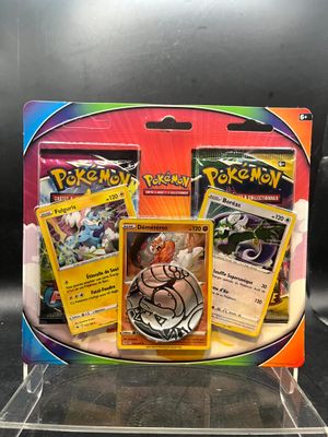 three pokemon cards in a display case on a table