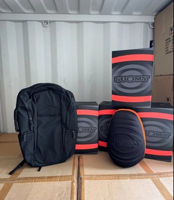 several boxes and a backpack sitting on top of a cardboard box