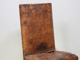 a wooden chair that has a seat made of wood