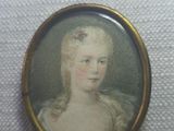 portrait of a woman in a white dress with a flower in her hair