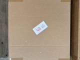 a cardboard box with a sticker on it sitting on the floor