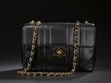 a black chanel bag with a gold chain strap