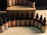 a wooden table topped with bottles of essential oils on top of it