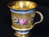 an image of a gold cup with flowers on it