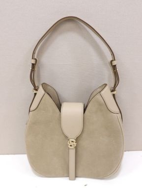 a white purse with a tan handle on a white surface