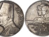 an image of a silver coin with an image of a man in a turban