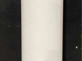 a tall white vase sitting on the floor