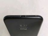 the back view of a black iphone with a camera attached to the back of it