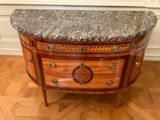 a marble top on a wooden cabinet in a room