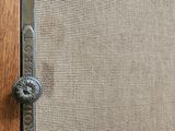 a close up of a door handle on a wooden door