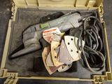 a tool in a tool box with a cord and a drill