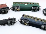 several toy trains are lined up in a circle on a white surface
