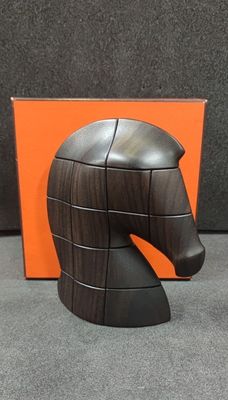 a wooden horse head sculpture on display next to an orange box