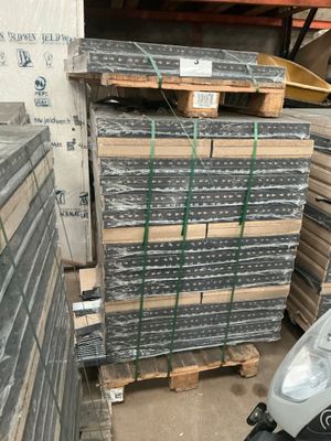 a scooter that is parked in front of a pile of pallets