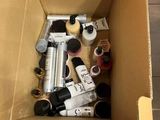 a cardboard box filled with different types of paint