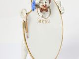 an image of a figurine of a man holding a mirror