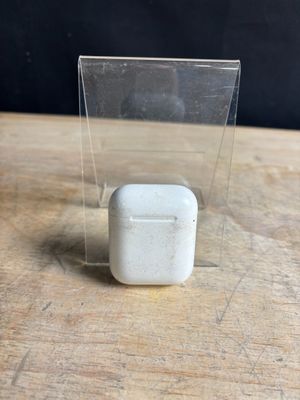 clear plastic box with a small white object in it on a wooden table