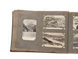 an open book with pictures of mountains and animals on it