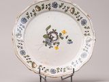 a white plate with blue and yellow flowers on it