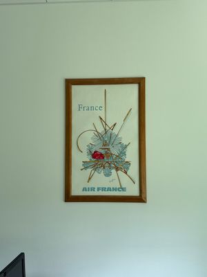 a picture of a picture hanging on the wall above a bed