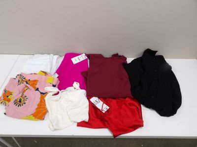 une table blanche sur laquelle sont posés un tas de vêtements