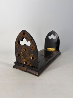 a wooden bookend with a clock on top of it