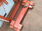 an aerial view of a man standing next to a red lift truck
