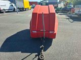 a red trailer that is parked in a parking lot
