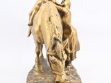 a statue of a man riding a horse with a woman on it