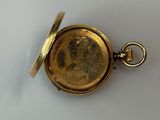 an image of a close up of a pocket watch on a white surface