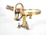 an old brass microscope with a magnifying glass on a stand
