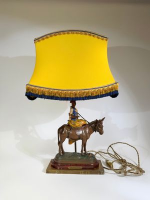 a lamp that has a horse on it with a yellow shade