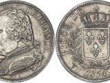 a silver coin with a crown on top of it