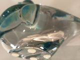 a glass bird that is sitting on a table